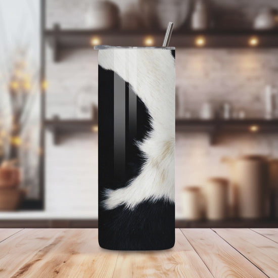 20oz stainless steel tumbler with a trendy black-and-white cow print, sized for Starbucks Venti drinks. Features double-wall insulation to keep beverages hot for up to 6 hours and cold for up to 12 hours. Comes with a spill-resistant lid and straw, perfect for eco-friendly, reusable travel. Actual product color may vary from the images shown.